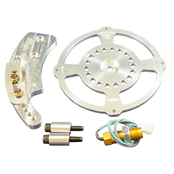 The Innovators West Small Block Chevy 4-Magnet Crank Trigger Kit #7006 includes a metallic circular part with holes, a curved bracket, two cylindrical fasteners, a sensor, and a multicolored wire.